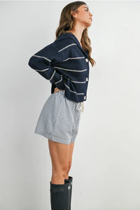 Navy blue striped collared cardigan with white stripes and drawstring hem