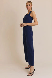 Navy blue jumpsuit from Shop Daisy’s womens boho clothes collection featuring a square neck