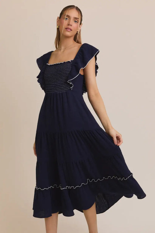 Navy blue midi dress featuring a square neck ruffle and ruffle sleeve smocking