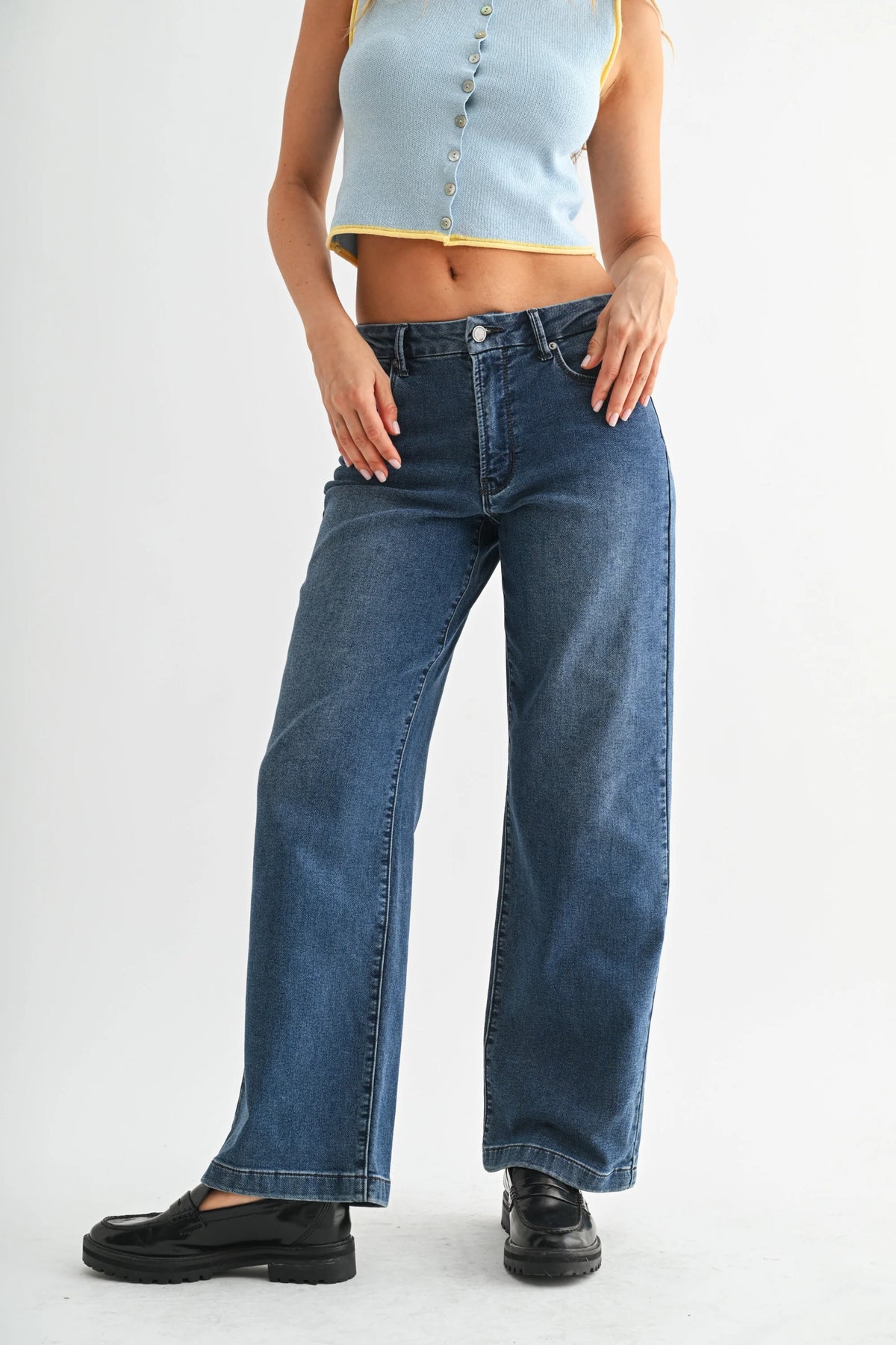 Mid rise slim wide leg sweat denim jeans in dark blue displayed in product image