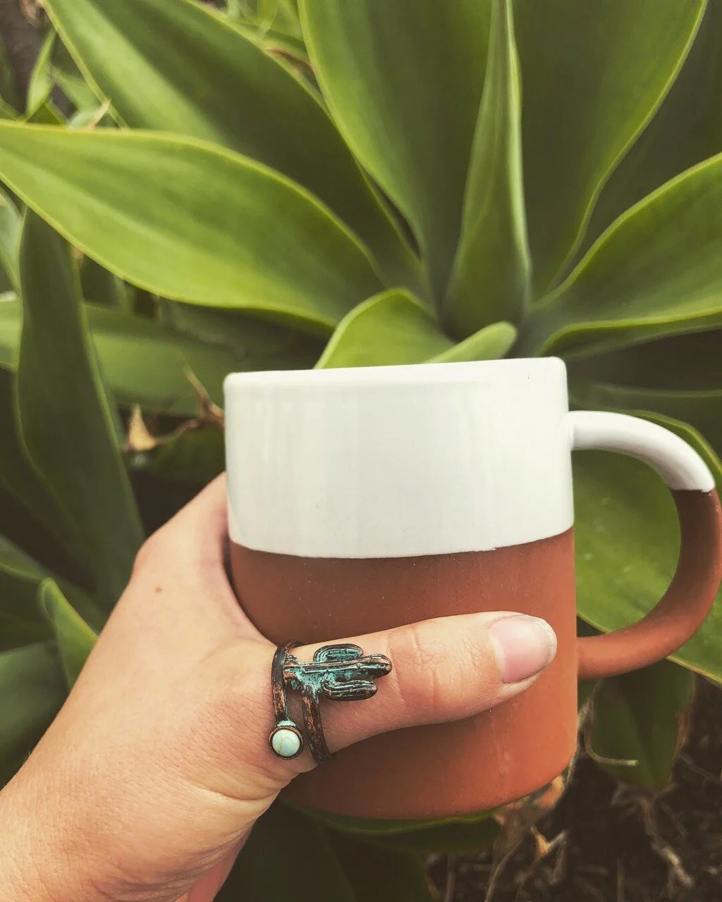 Person holding a mug with a frog while showcasing a Cactus Wrap Ring
