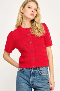 Red knit cardigan with decorative buttons from Shop Daisy, perfect for women’s boho chic clothing
