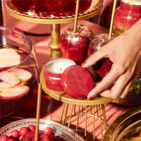 Red round apple cider social glimmer mini tin candle with gold metallic lid and base