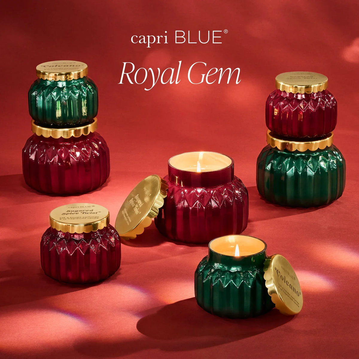 Royal gem volcano Capri Blue Signature candles in textured green and red glass jars with gold lids