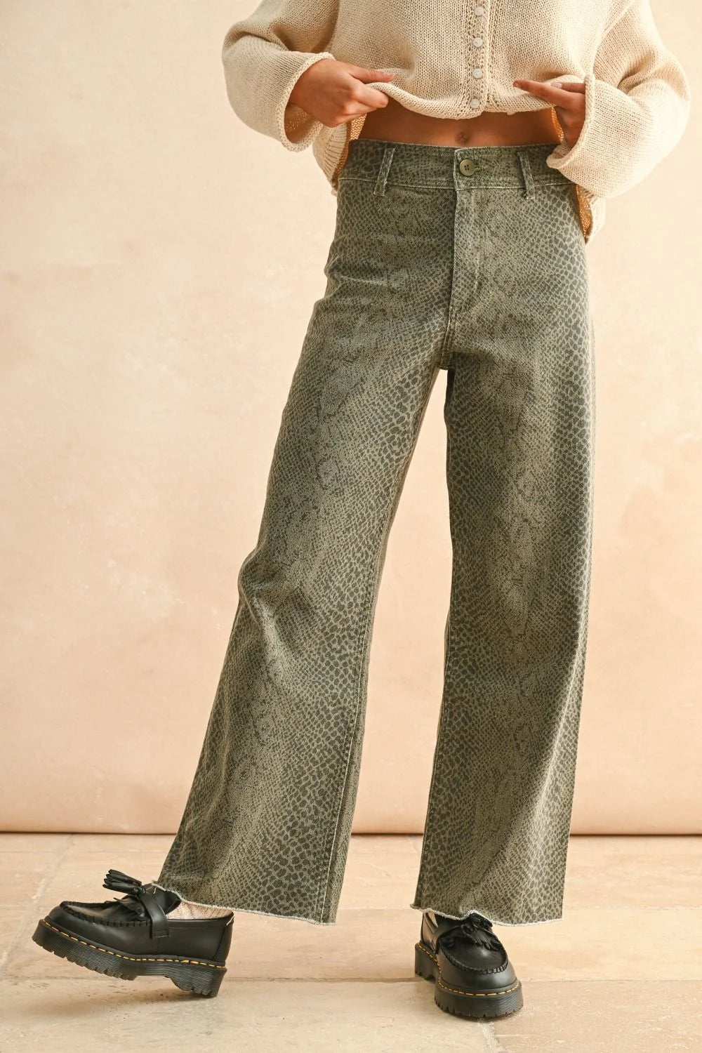 Woman wearing snakeskin pattern wide-leg jeans from SNAKE PRINT PANTS collection
