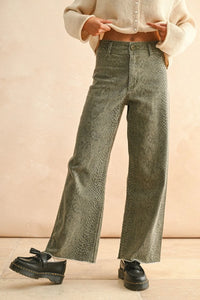 Woman wearing snakeskin pattern wide-leg jeans from SNAKE PRINT PANTS collection