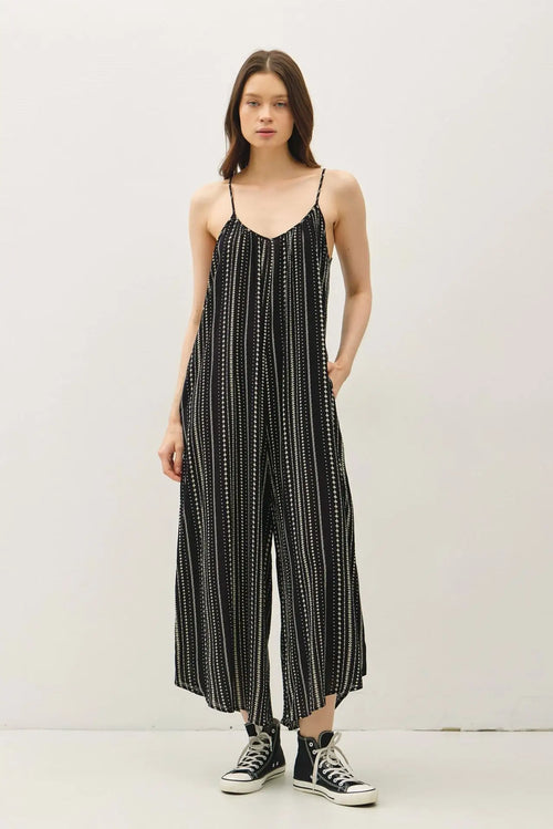 Printed breezy wide leg jumpsuit featuring black and white stripes, perfect for womenās boho chic clothing