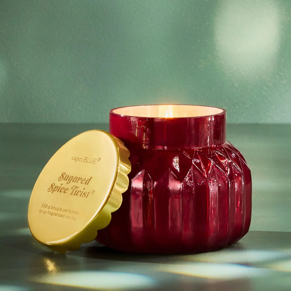 Sugared spice twist candle in textured burgundy glass jar with gold lid by Capri Blue