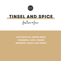 Tinsel Spice Glimmer Mini Tin Candle with festive juniper, cinnamon, clove, orange, vanilla, and forest scents