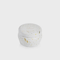 White candle in a round VOLCANO GLIMMER MINI TIN CANDLE with gold speckles