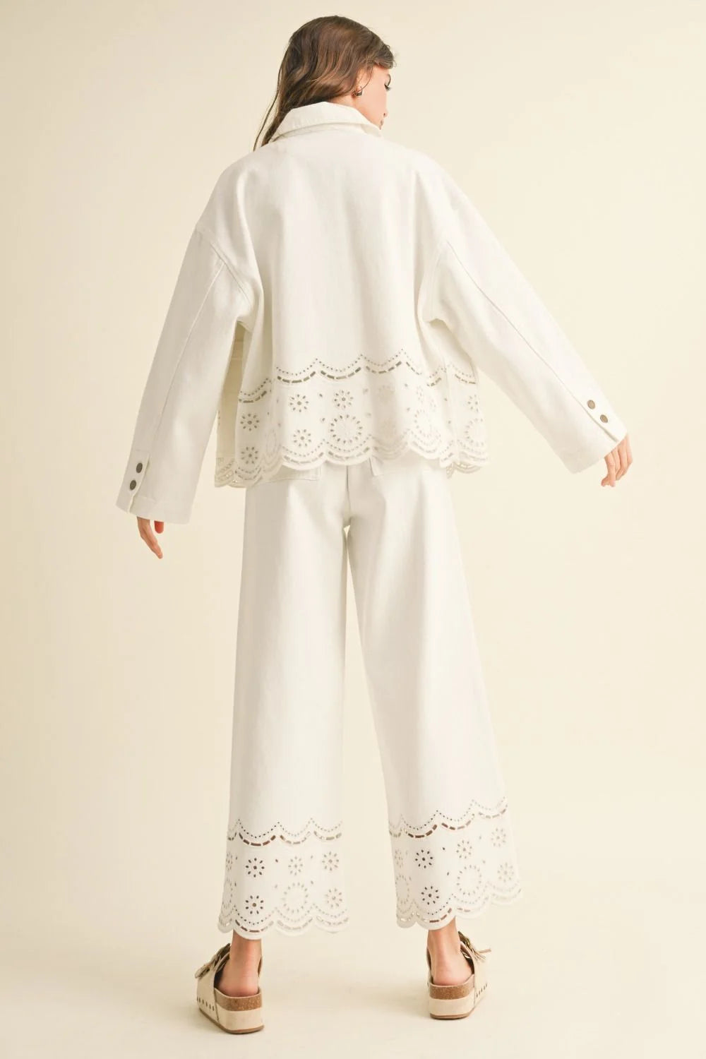 White eyelet-trimmed jacket and pants outfit from Shop Daisy, a stylish women’s boho chic clothing