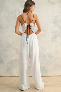 White open-back jumpsuit with contrast strap and spaghetti straps for stylish summer wear