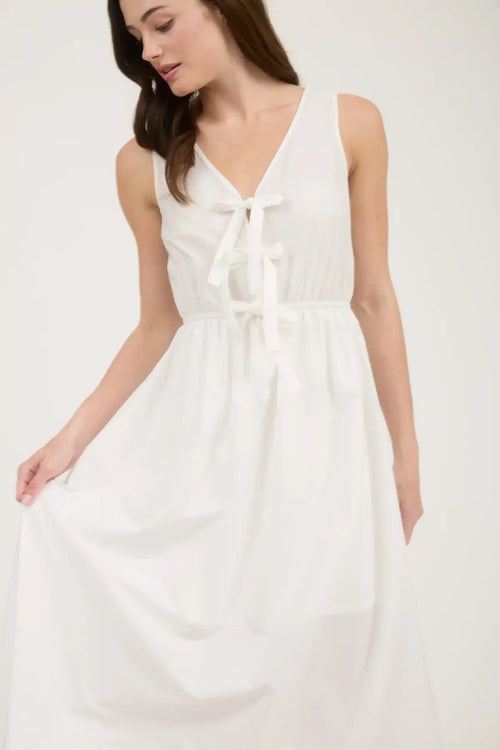 White sleeveless midi dress with bow tie detail and eyelet hem for elegant style