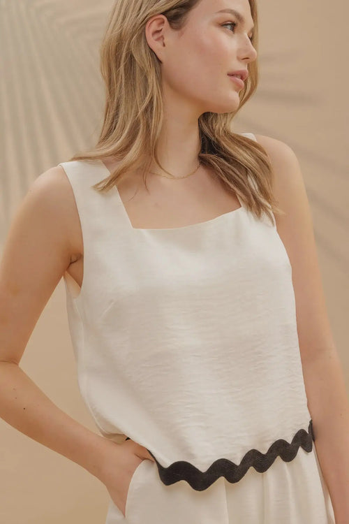 White tank top with black wavy contrast hem, ideal for summer fashion