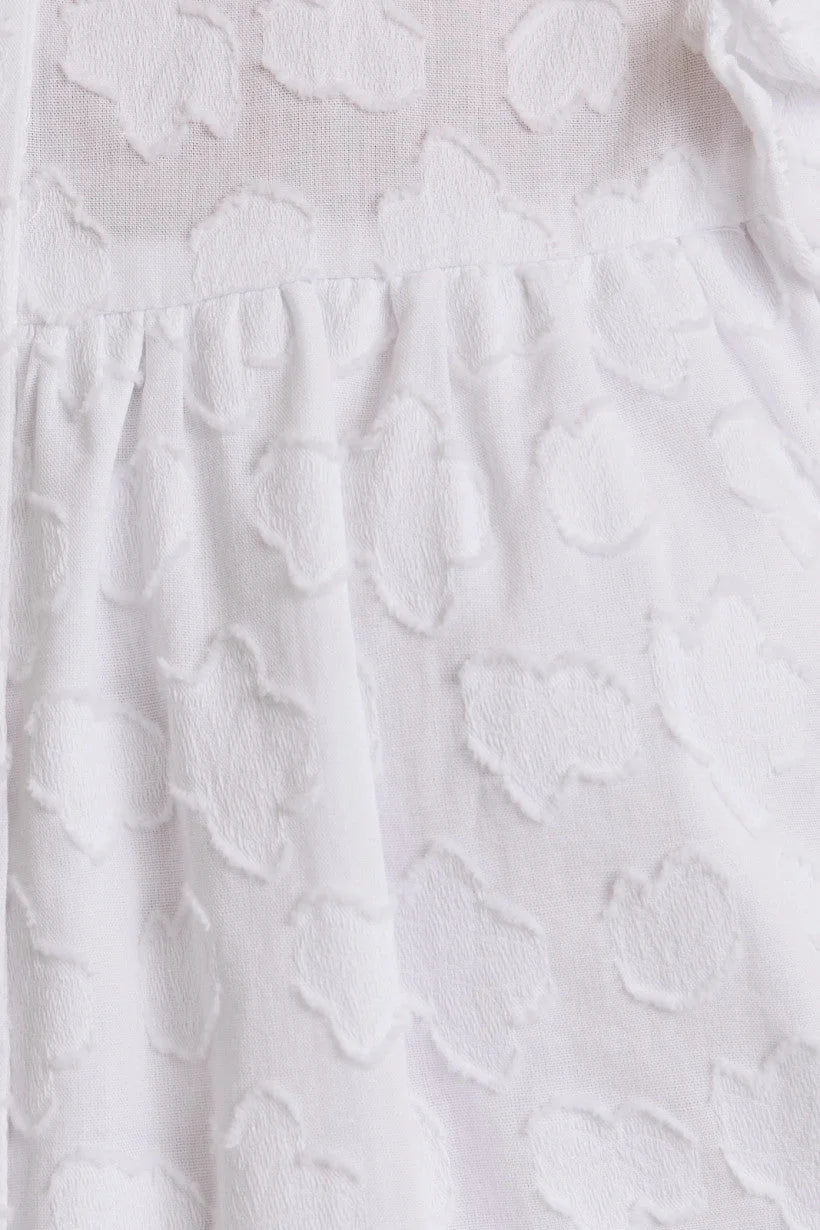 White textured fabric of the Round Neck Ruffle Sleeve Button Down Top with stylish ruffle sleeve design