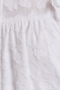 White textured fabric of the Round Neck Ruffle Sleeve Button Down Top with stylish ruffle sleeve design