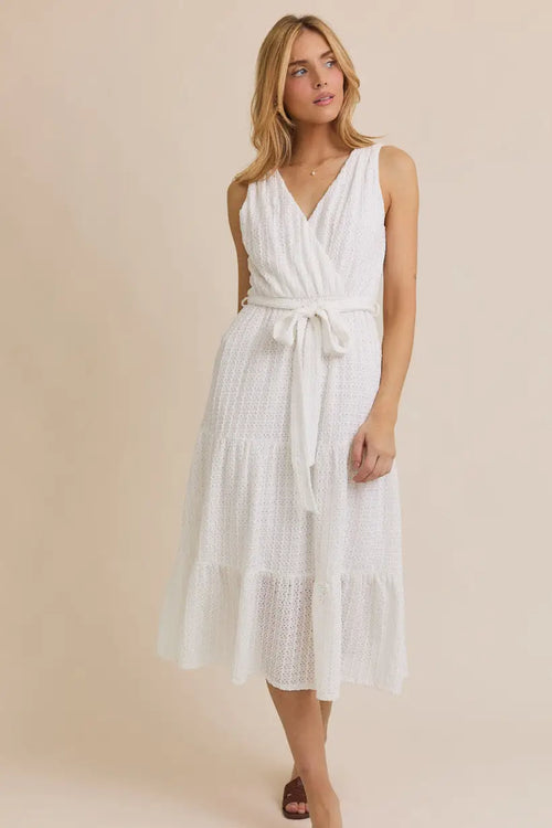 White surplice sleeveless waist tie eyelet midi dress displayed in product image