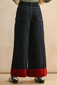 Wide leg dark denim contrasted cuffed pants with red velvet trim and high waist