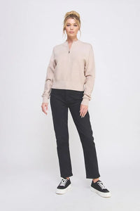 Woman wearing beige fine gauge dolman half zip sweater with twin texture rib fabric