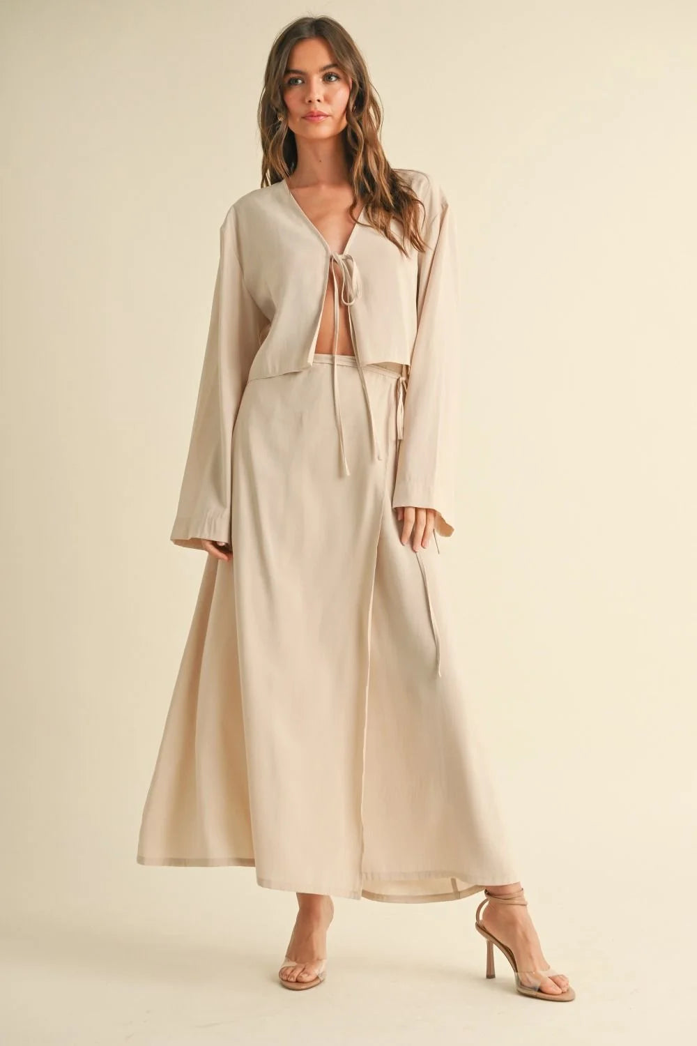 Woman wearing a beige tie-front long sleeve top from Viscose outfit collection