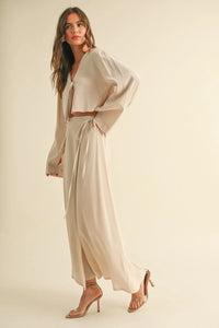 Woman in beige tie-front long sleeve top showcasing stylish outfit for women