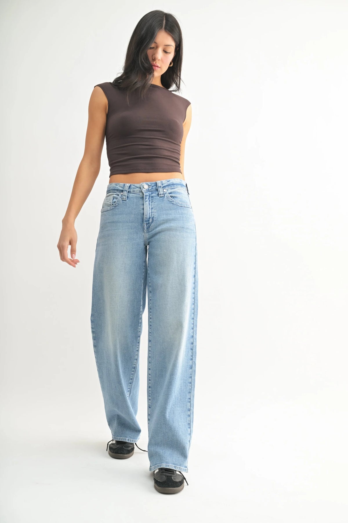 Woman in brown top wearing low slung vintage straight denim jeans