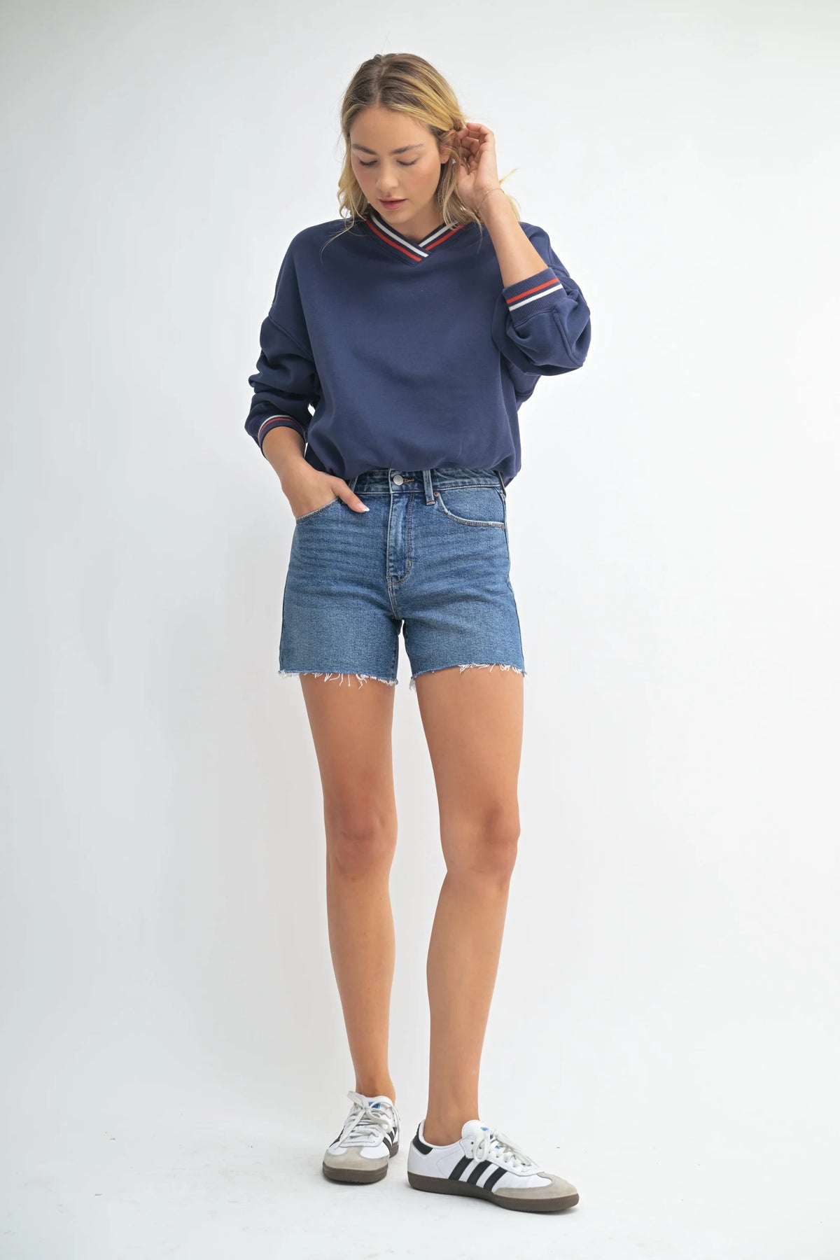 Woman in casual denim walking shorts featuring a longer length for comfortable everyday wear