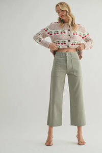 Woman in cherry cardigan and green pants wearing Nautical High Rise Wide Leg Denim