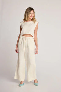 Woman in a cream-colored two-piece boho chic outfit from Shop Daisy Women’s Boho Clothes