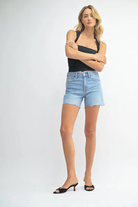 Woman wearing longer length denim walking shorts for comfortable casual wear