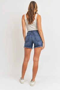 Woman wearing denim shorts from the MED-HI-LO Hem Detail Long Summer Short collection