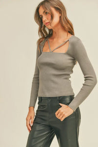 Woman in gray ribbed long sleeve top and dark leather pants from Shop Daisy