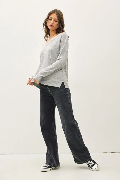 Woman wearing ultra soft long sleeve V-neck sweater in womenās boho chic clothing from Shop Daisy