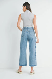 Woman in gray top and wide-leg jeans from HIGH RISE BARREL DENIM JEAN TWIST, Shop Daisy