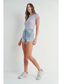 Woman in lavender top and denim shorts showcasing Vintage Frayed Hem Short Denim