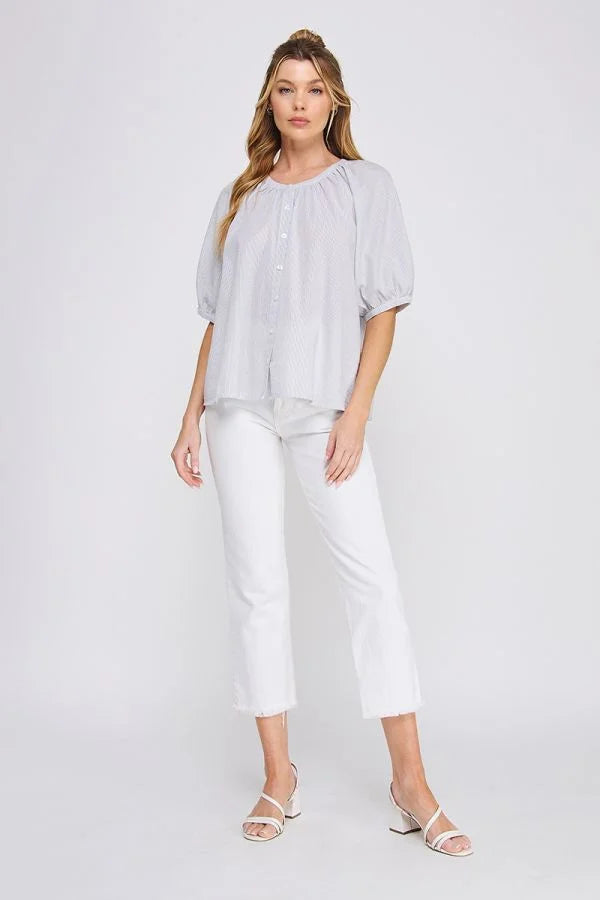 Woman in a light blue striped seersucker rayon-linen blend blouse from Daisy Lane