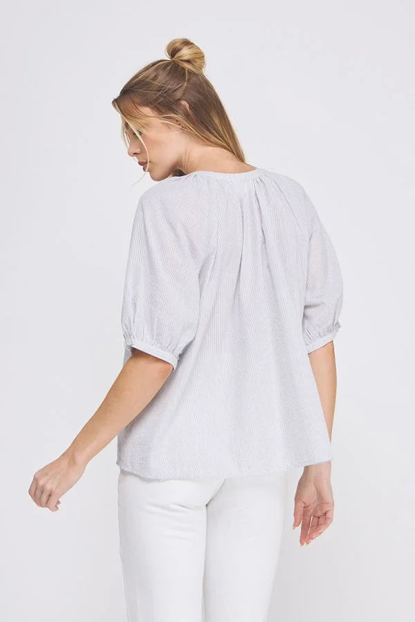 Woman in Daisy Lane’s striped seersucker rayon-linen blend short sleeve blouse