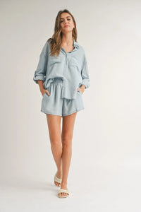 Woman in light blue linen shorts set from Shop Daisy, perfect for women’s boho chic clothing
