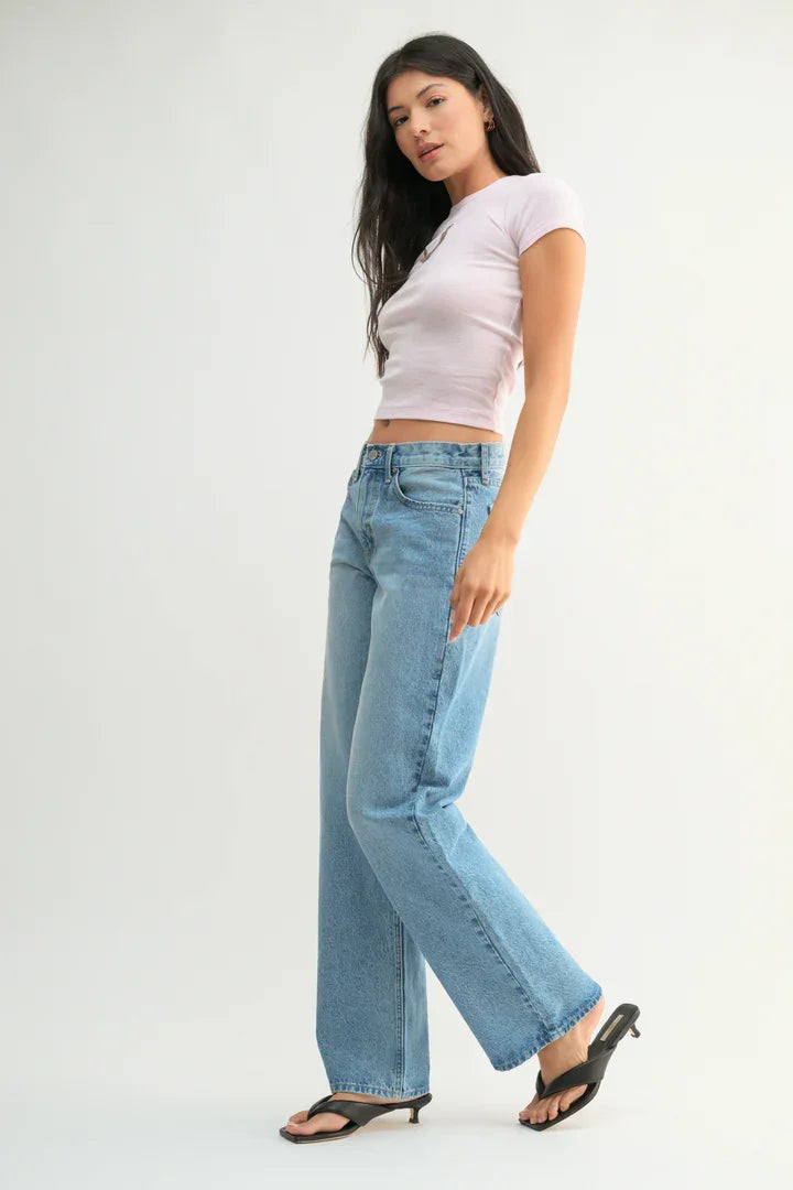 Woman in light blue jeans and pink top showcasing Relaxed Straight Leg Denim Jean