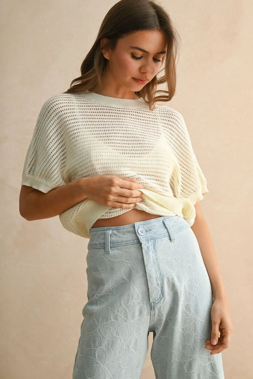 Woman wearing a light-colored knitted surplice back detail top, perfect for womenās boho chic clothing from Shop Daisy