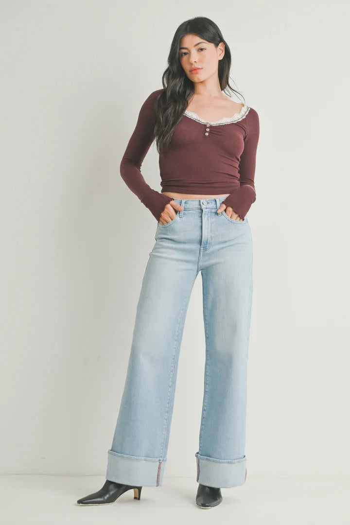Woman wearing cuffed high rise palazzo denim jeans and a long-sleeved top outdoor