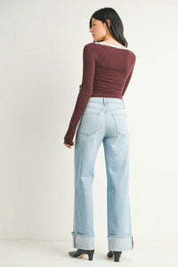 Woman wearing cuffed high rise palazzo denim jeans and a long-sleeved top