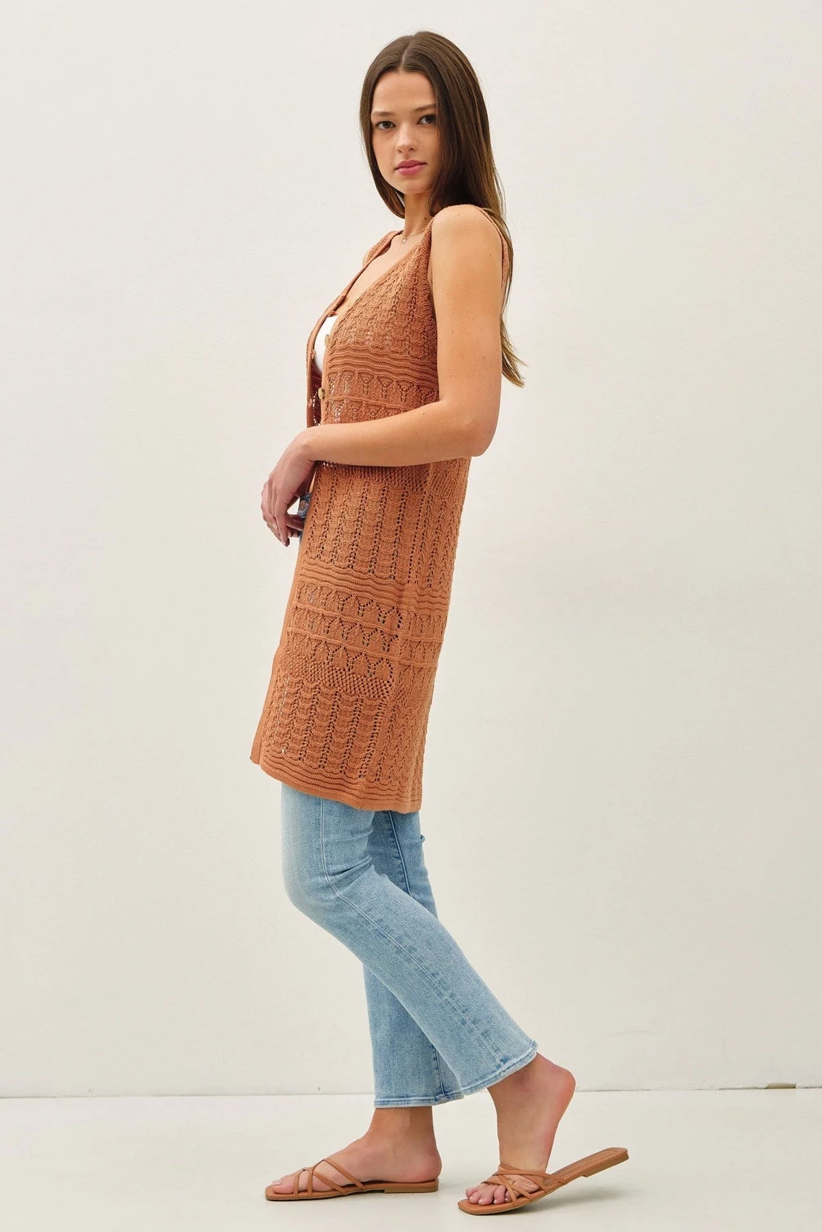 Woman wearing a long crochet knit duster, perfect for women’s boho chic clothing, Shop Daisy