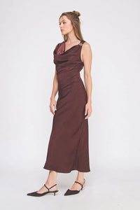 Woman modeling a draped sleeveless midi dress with buckle strap and black slingback heels