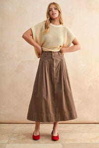 Woman modeling MINI PLEAT DETAILED LONG SKIRT with cream knit top and red flats