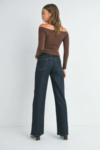 Woman from behind wearing high rise relaxed wide leg denim jeans and brown off-the-shoulder top