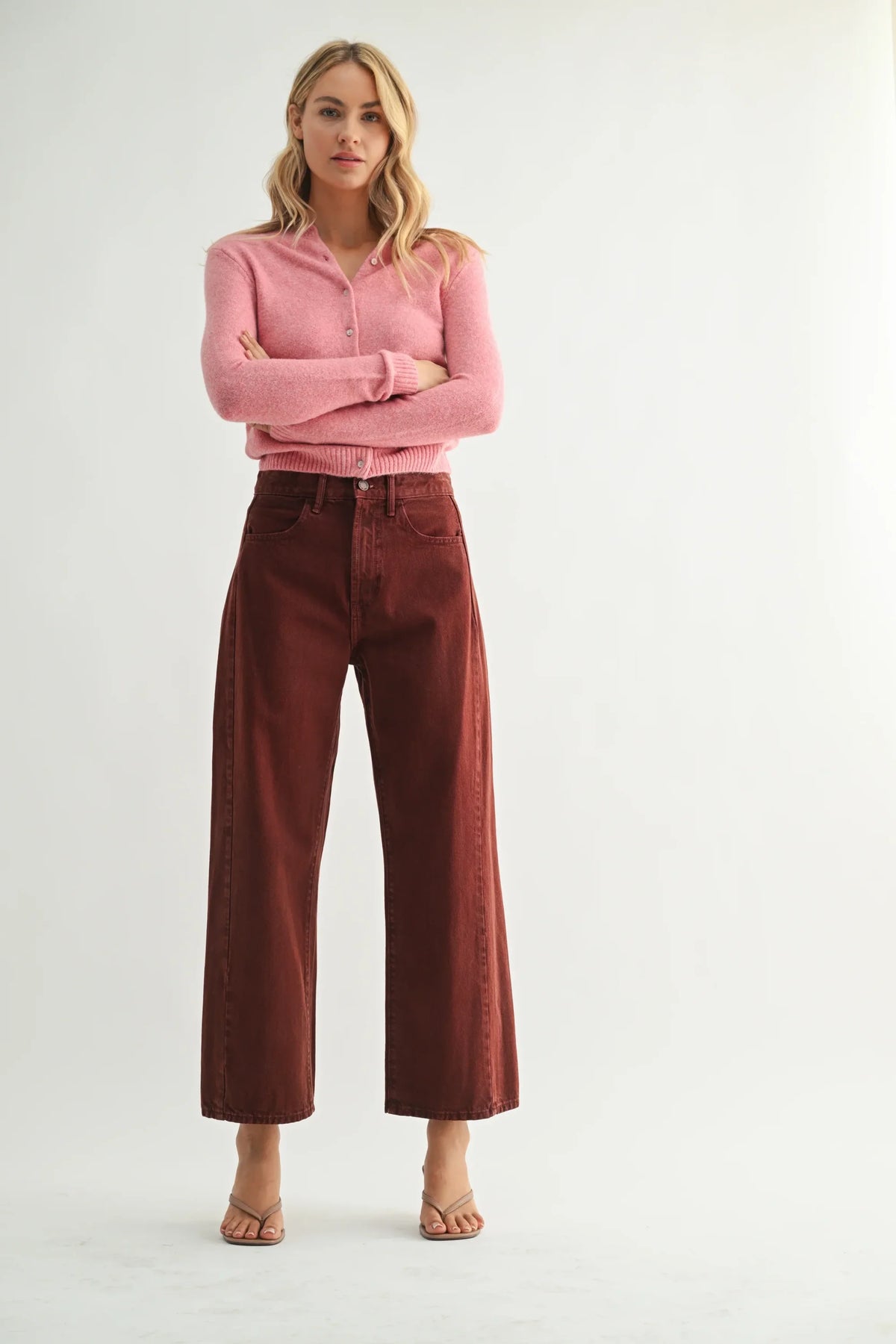 Woman wearing pink cardigan and brown high-rise barrel denim jeans showcasing women’s boho chic clothing at Shop Daisy