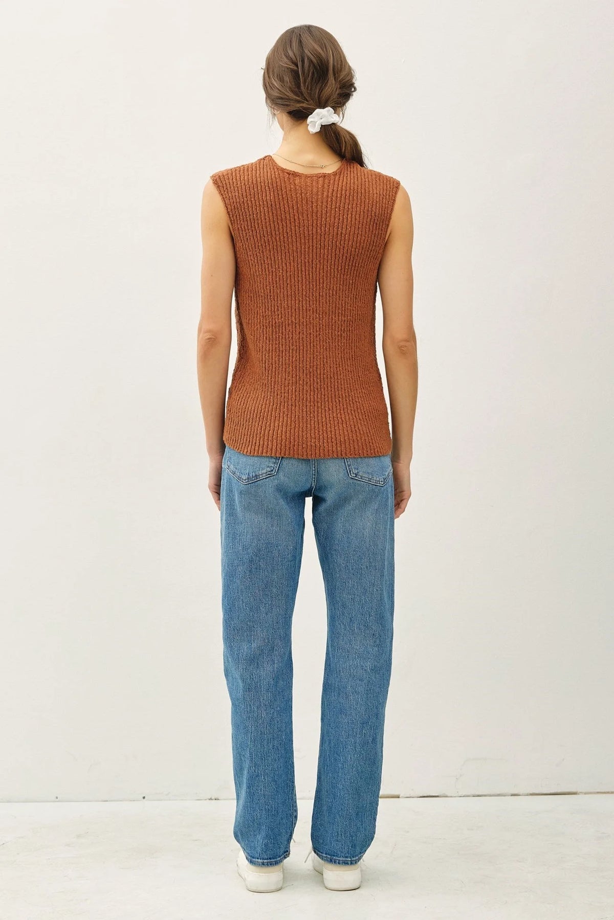 Woman wearing a ribbed knit top and jeans in women’s boho chic clothing from Shop Daisy