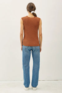 Woman wearing a ribbed knit top and jeans in women’s boho chic clothing from Shop Daisy