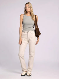 Woman in an Edlin Basic Tank paired with light-colored jeans, showcasing casual style